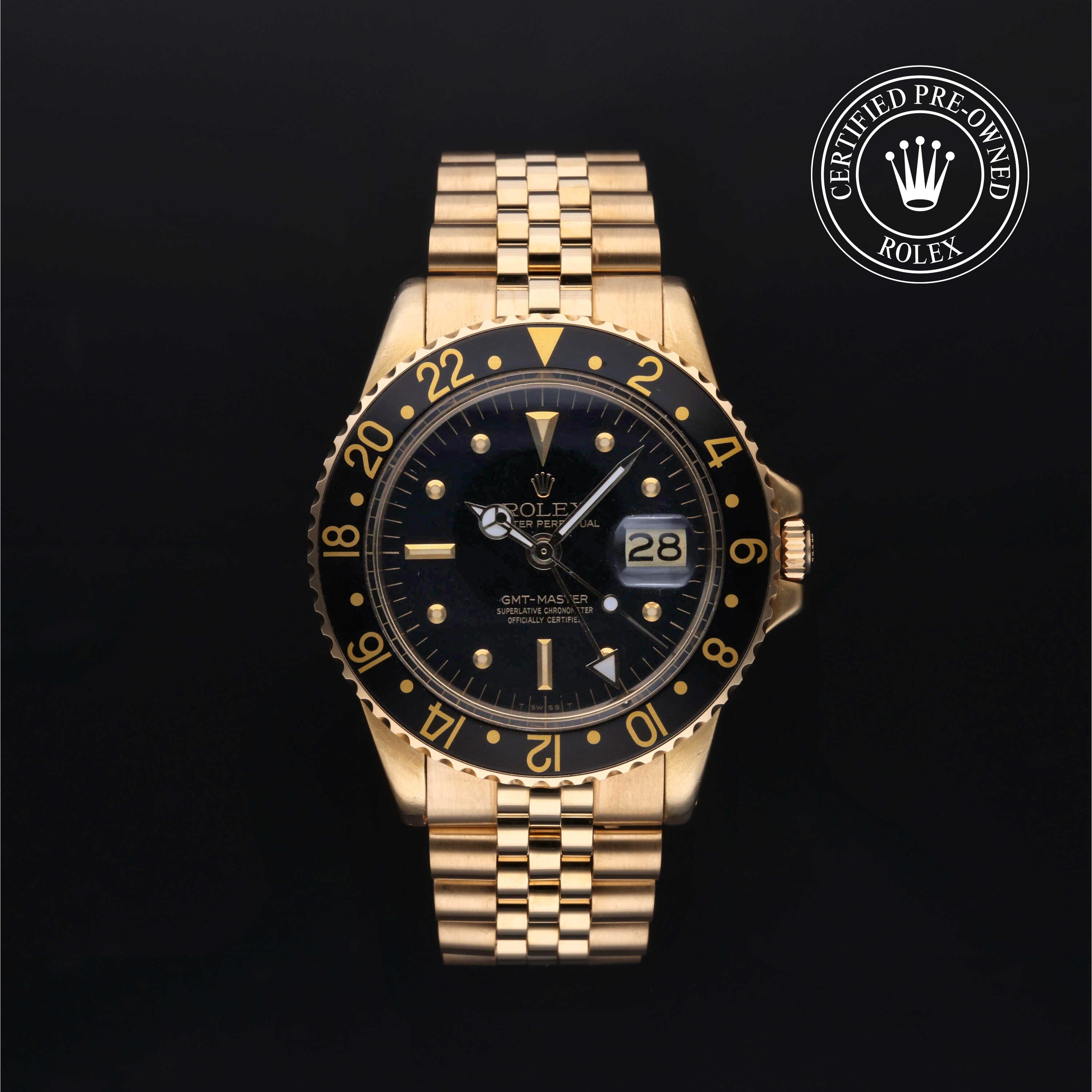 Front view of Rolex GMT-Master 18k yellow gold with black dial and bezel, date window, Certified Pre-Owned Rolex emblem