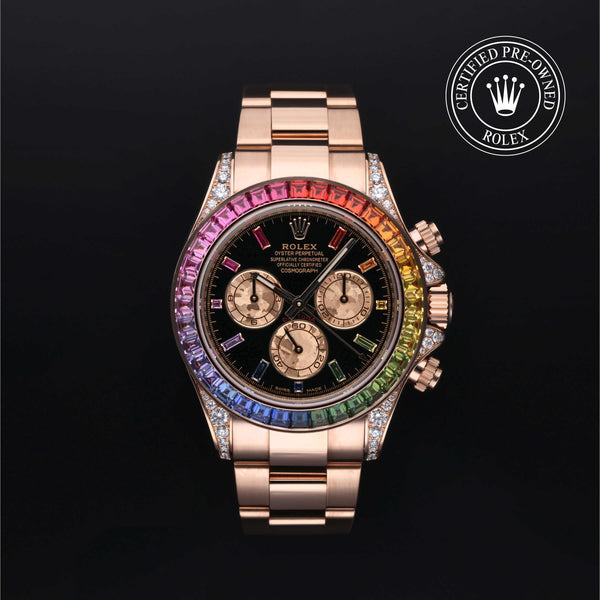 A luxury Rolex Daytona watch with a rose gold-tone case and bracelet, featuring a black dial and a vibrant rainbow-colored bezel. The watch is presented on a solid black background with a 'Certified Pre-Owned Rolex' emblem in the top right corner.