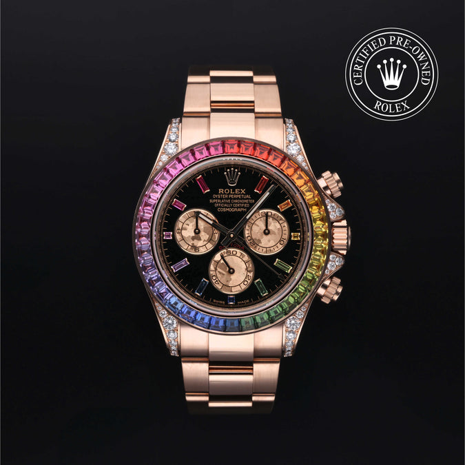 A luxury Rolex Daytona watch with a rose gold-tone case and bracelet, featuring a black dial and a vibrant rainbow-colored bezel. The watch is presented on a solid black background with a 'Certified Pre-Owned Rolex' emblem in the top right corner.