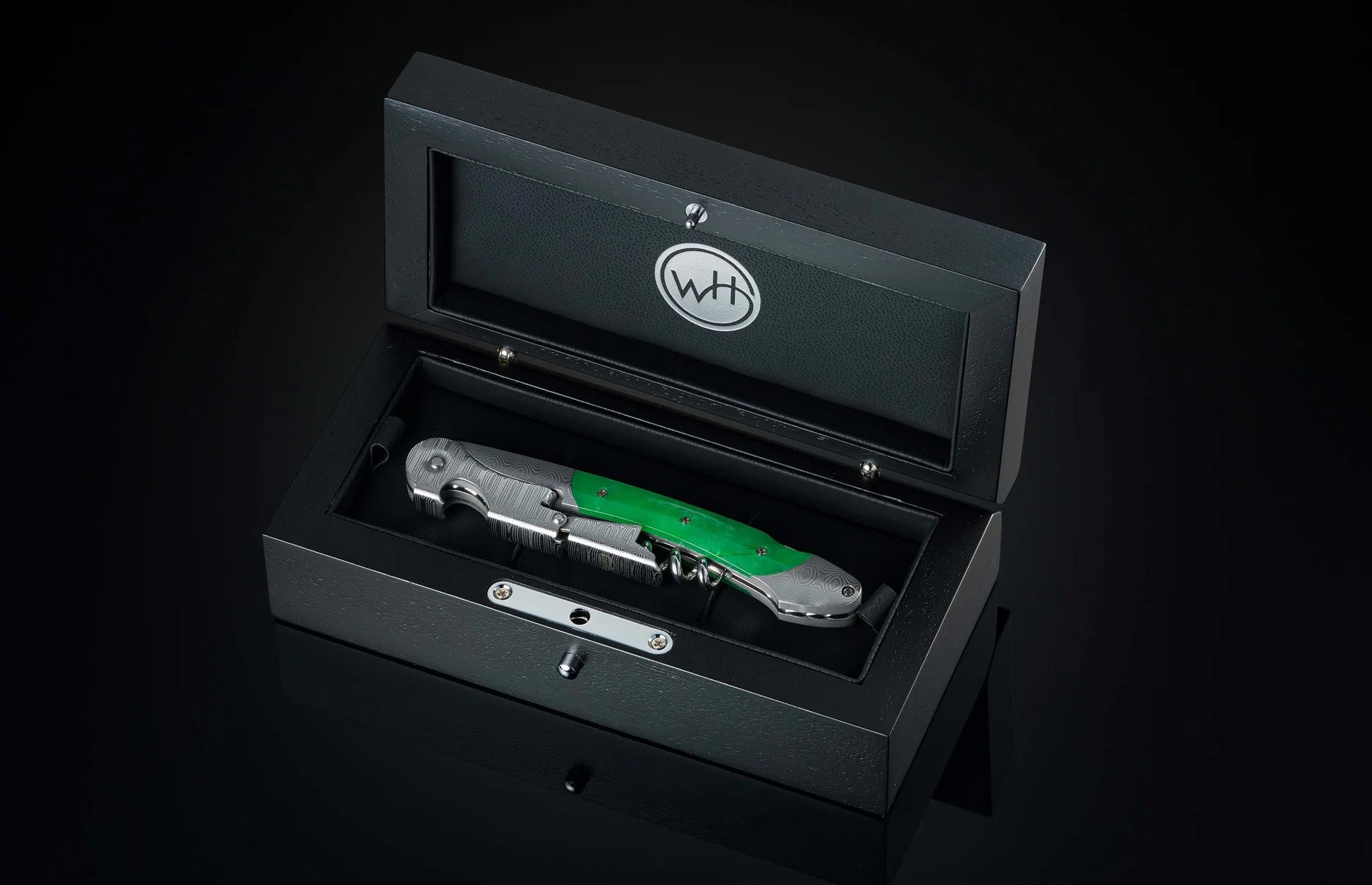 Angled view of William Henry Canopy wine opener corkscrew showcasing green handle and foil cutter in open black box