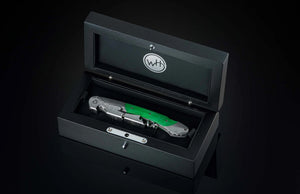 Angled view of William Henry Canopy wine opener corkscrew showcasing green handle and foil cutter in open black box