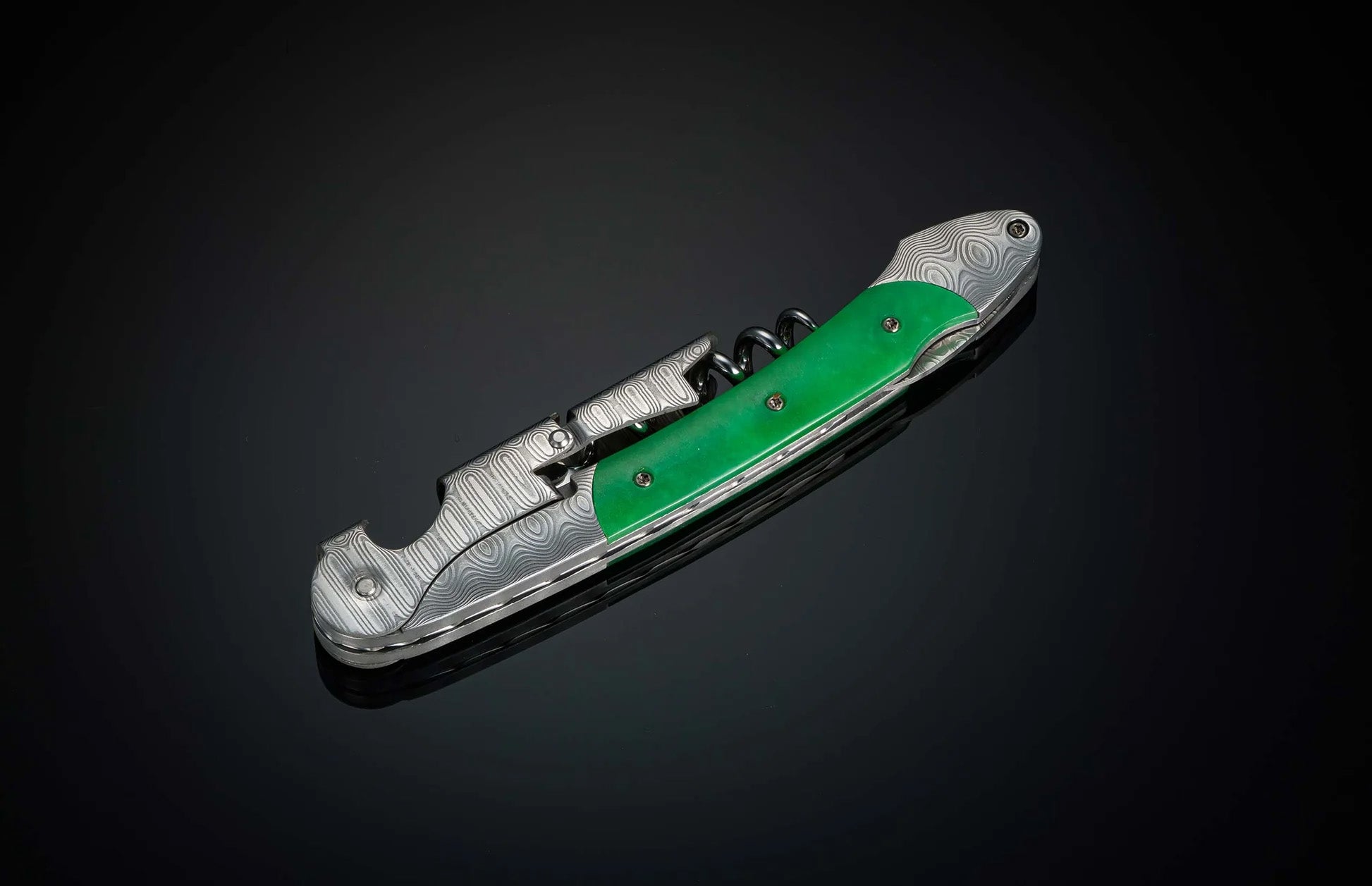 Angled view of William Henry Canopy wine opener and corkscrew with patterned steel and green handle on black background