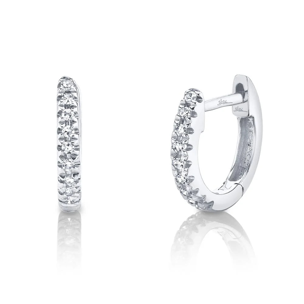 Hinged sterling-silver huggie hoop earrings with pavé round clear stones, shown front and side.