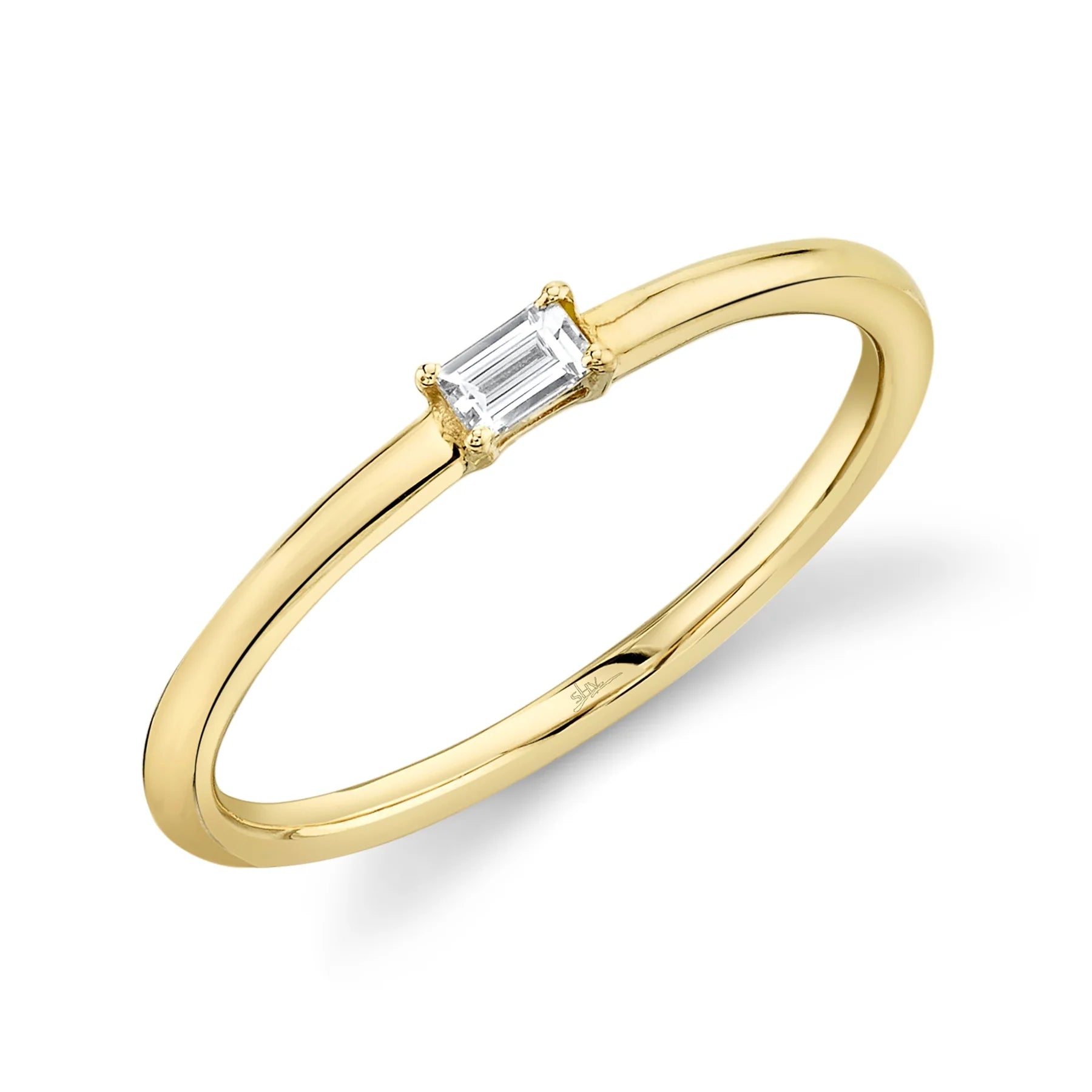 Thin yellow gold band with a small emerald-cut diamond in a four-prong setting.