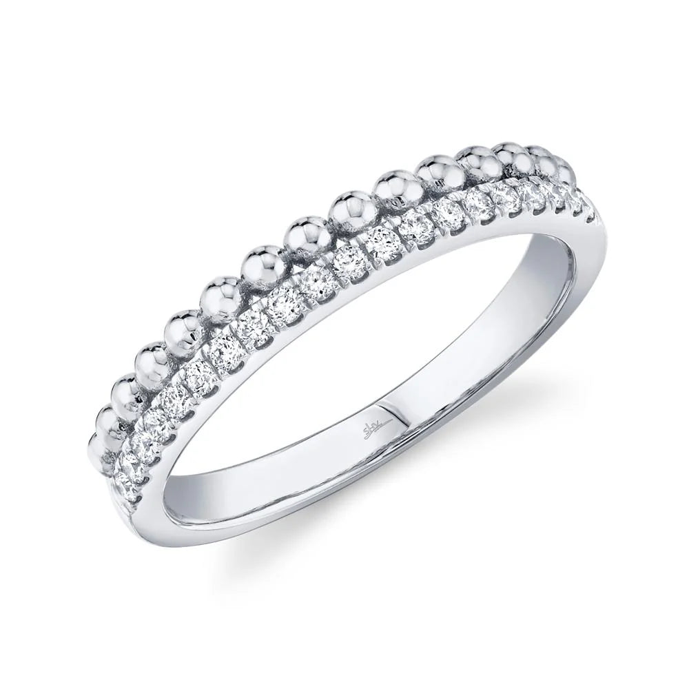 White gold band with a row of pavé diamonds and a beaded edge.