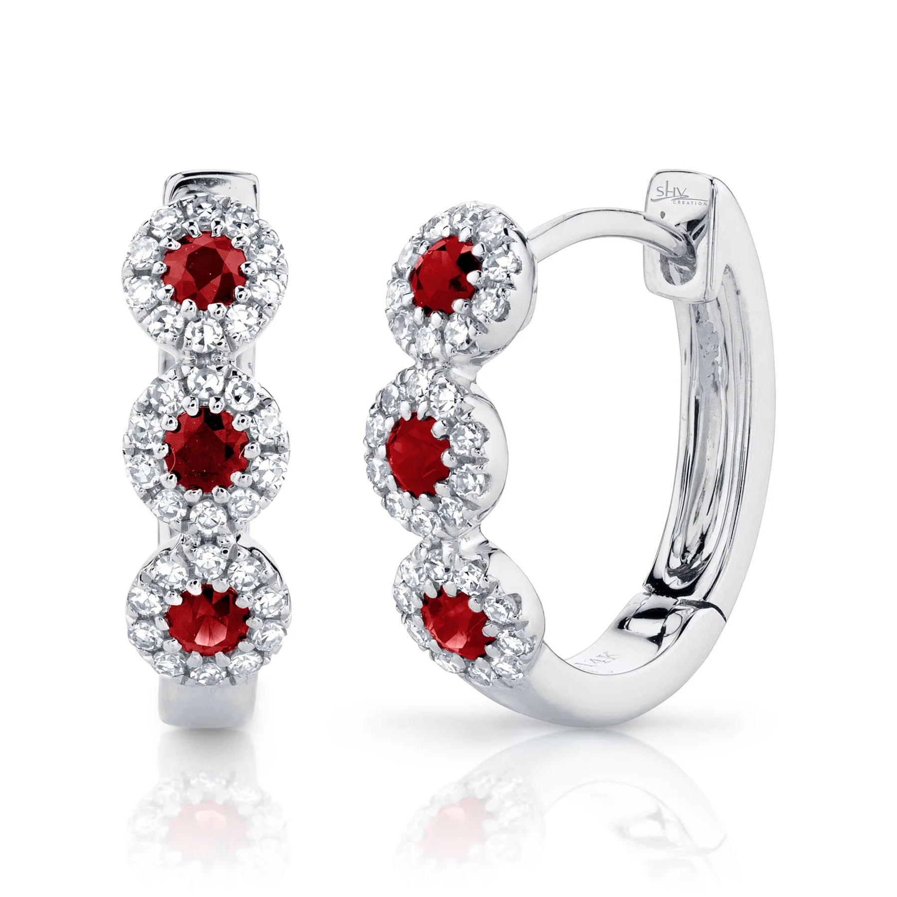 Sterling silver hoop earrings with three red round gemstones, each surrounded by a halo of clear stones