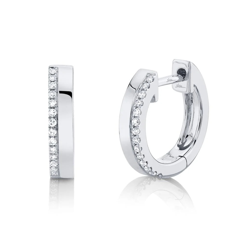 Pair of sterling silver hoop earrings with a row of pavé crystals; one closed and one open showing the hinge.