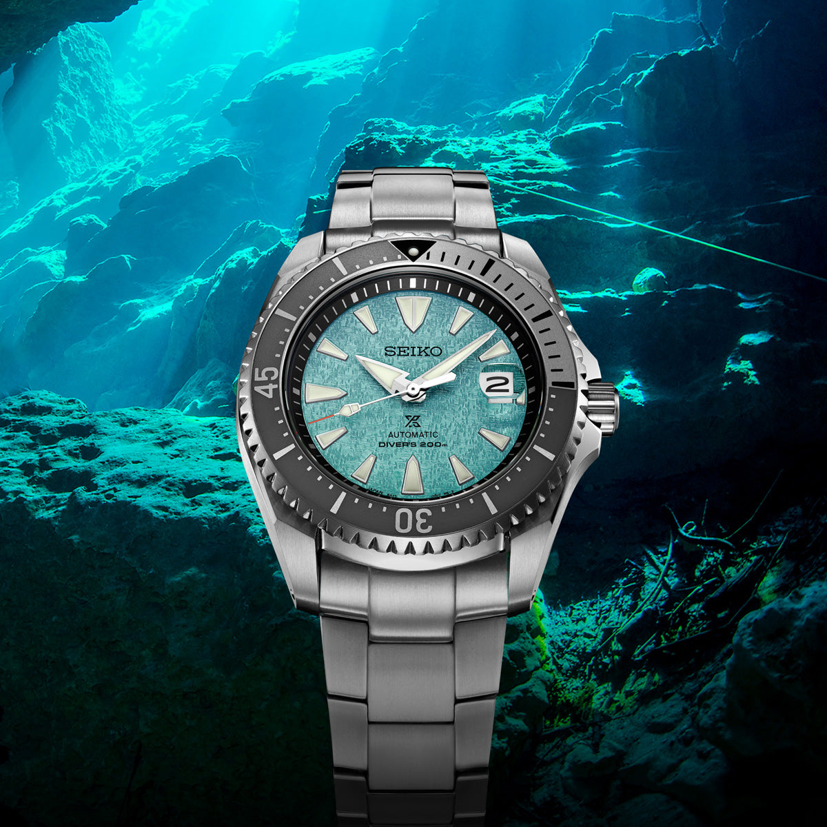 Seiko watch with a blue gradient dial against an underwater background