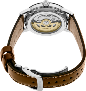 Rear view of Seiko SRPE45 showing exhibition caseback with gold rotor and brown leather strap on white background
