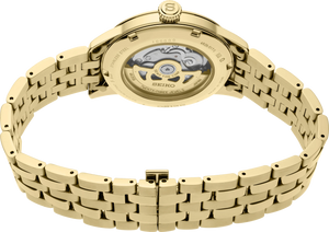 Gold Seiko watch with a detailed mechanism on a white background