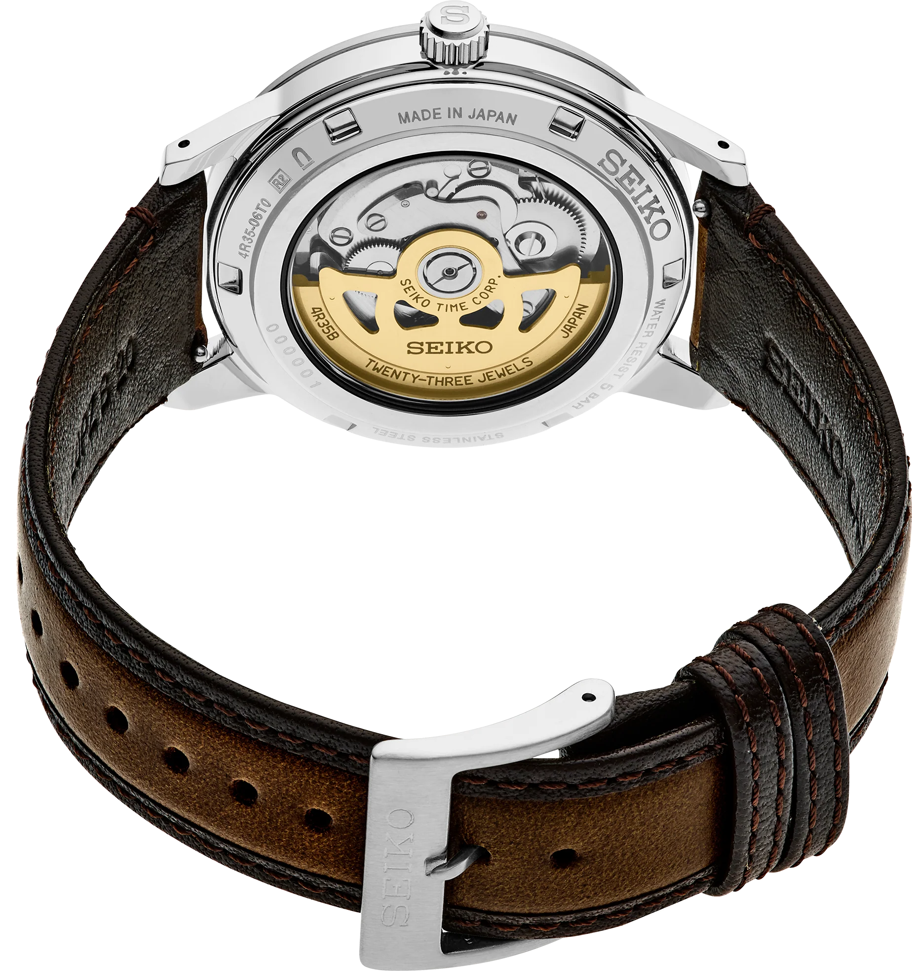 Rear view of a Seiko watch with a silver stainless steel case and a brown leather strap, showing the gold-toned mechanical movement through a transparent back.