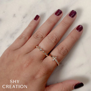 Hand wearing two gold diamond rings on middle and ring finger; SHY CREATION logo visible.