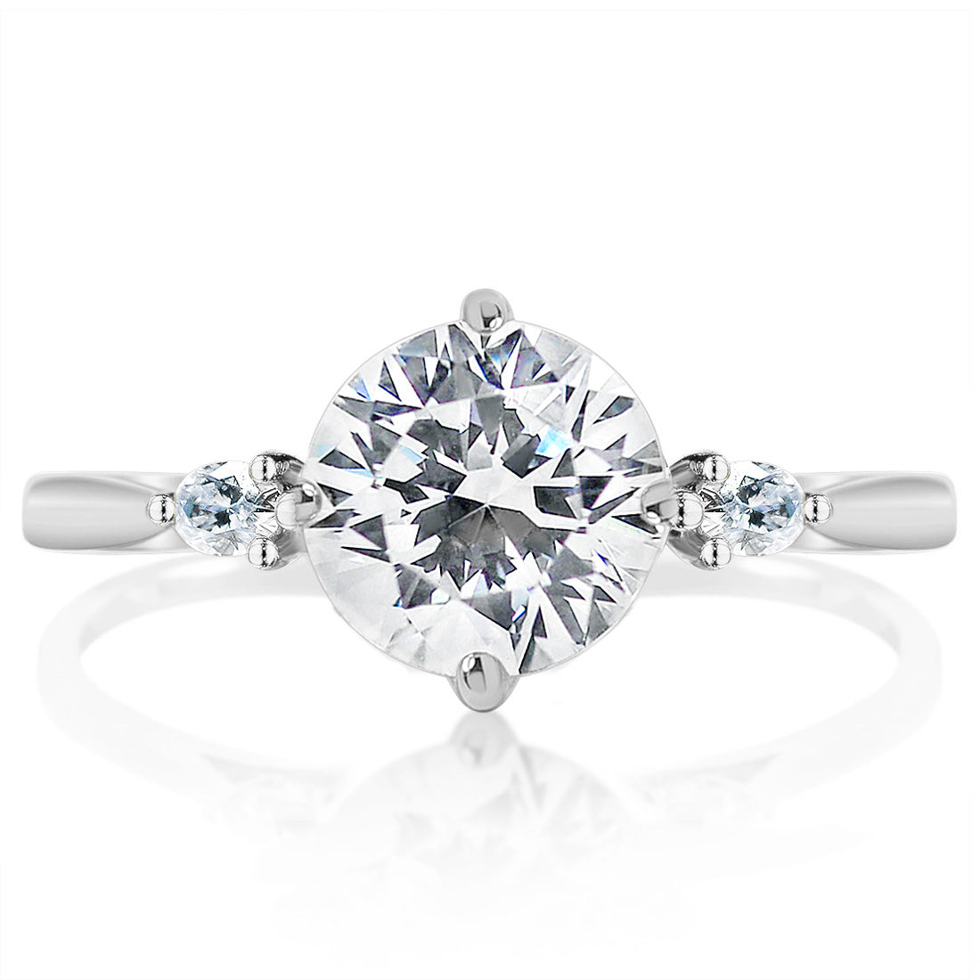 Round brilliant solitaire diamond with two small marquise side stones on a polished white-metal engagement ring band