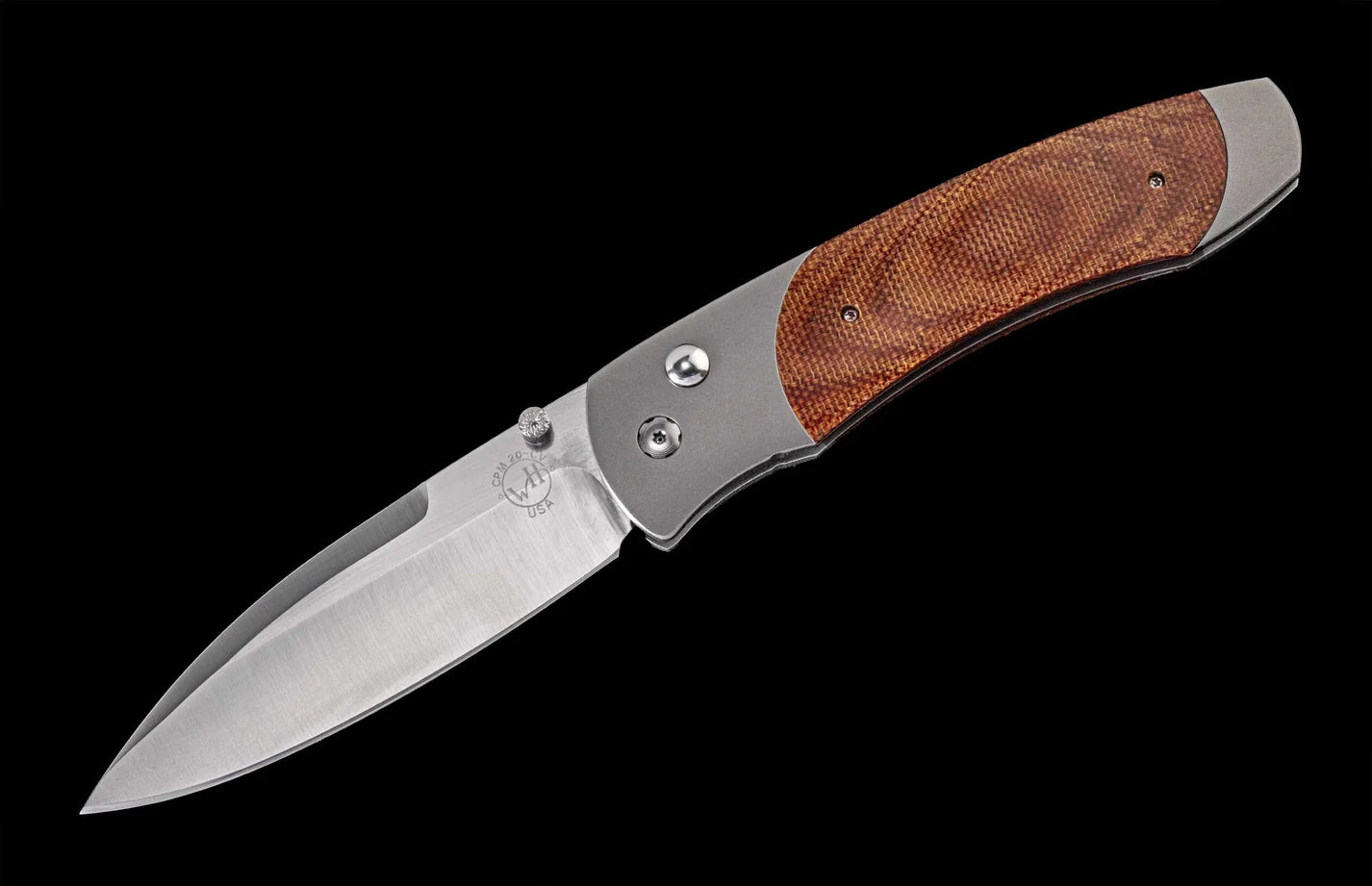 Folding knife with wooden handle on a black background