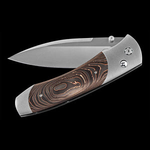 Folding knife with wooden handle on a black background