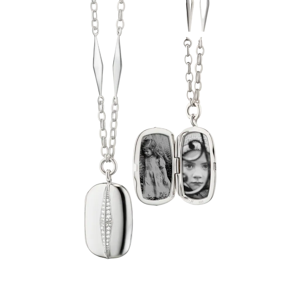 Silver locket necklace with white sapphires that holds 2 images on a white background
