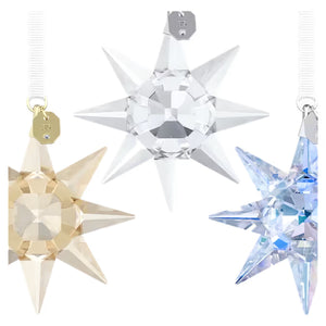 close up of 3 star ornaments in brown, blue and clear crystals with white ribbon on a white background