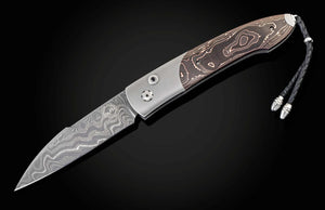 Folding knife with decorative handle on a black background