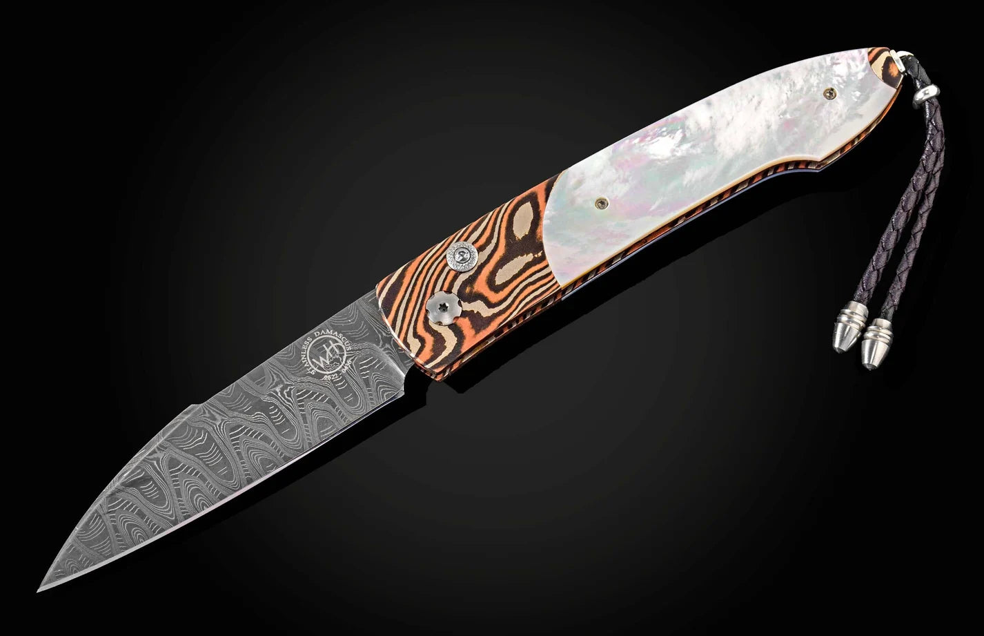 An open folding pocket knife with a patterned Damascus steel blade, a white mother-of-pearl inlay, and a handle featuring orange, brown, and black wood grain swirls, shown against a dark background.