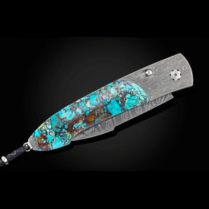 A folding pocket knife with a textured silver steel blade and a handle inlaid with vibrant turquoise, brown, and orange natural stone. The knife is shown open against a dark black background.