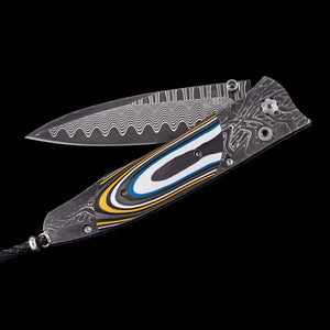 A Damascus steel folding pocket knife with a patterned blade and a decorative handle featuring black, white, blue, and yellow inlay, shown against a solid black background.