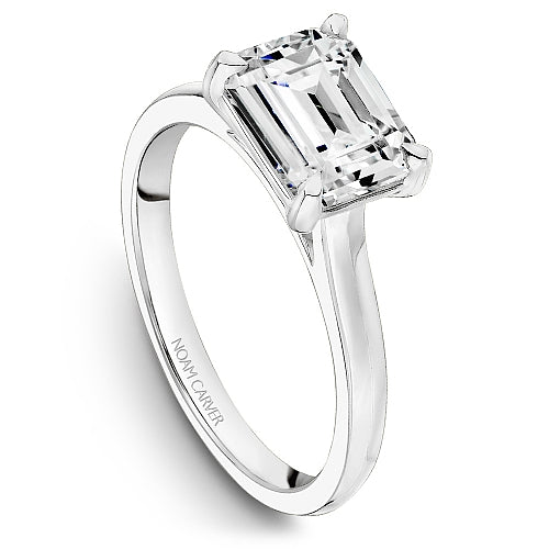 Three-quarter view of 14K white gold engagement mounting showing an emerald-cut four-prong solitaire setting on a white background