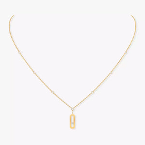 Gold necklace with a rectangular pendant on a white background