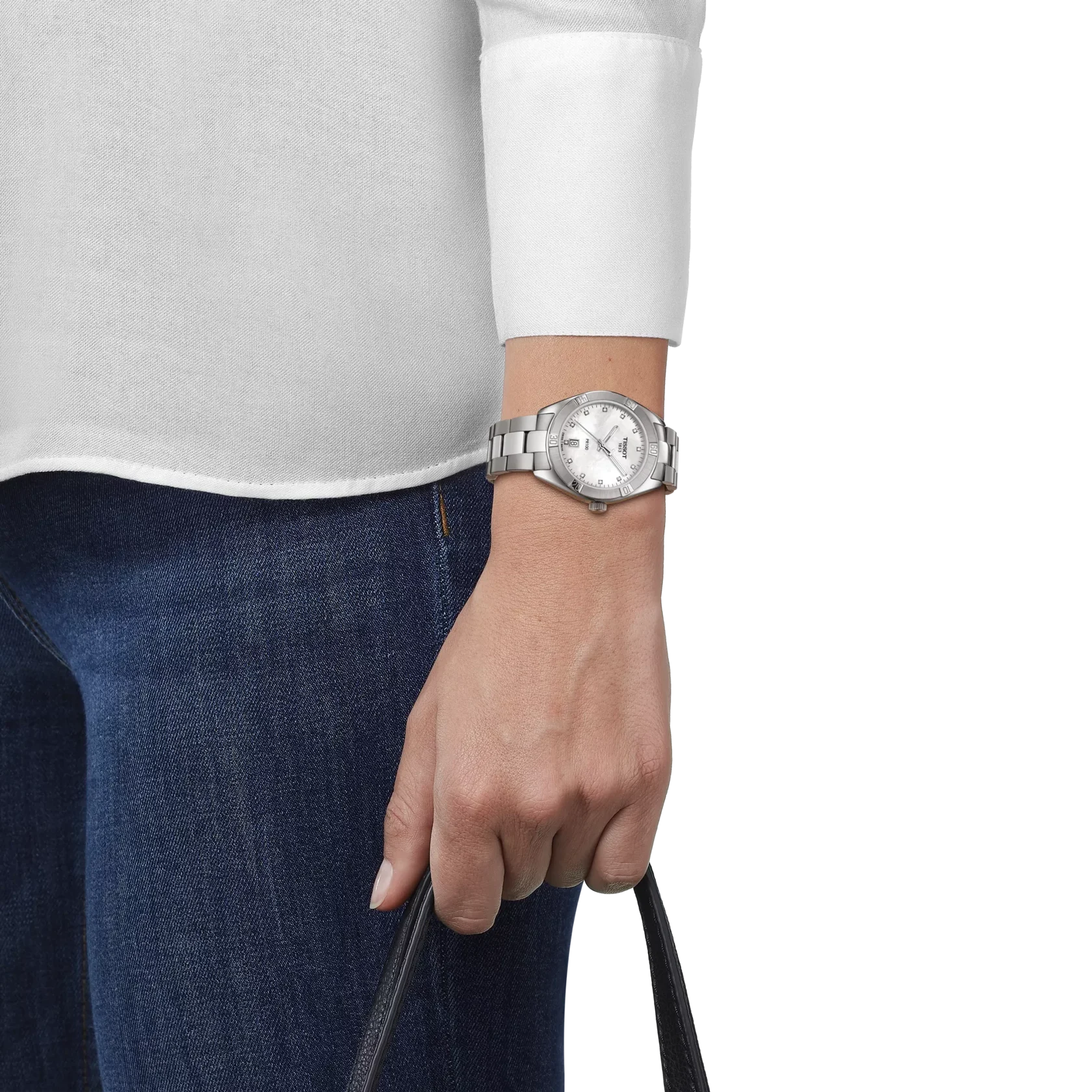 Person wearing a silver watch on a white background
