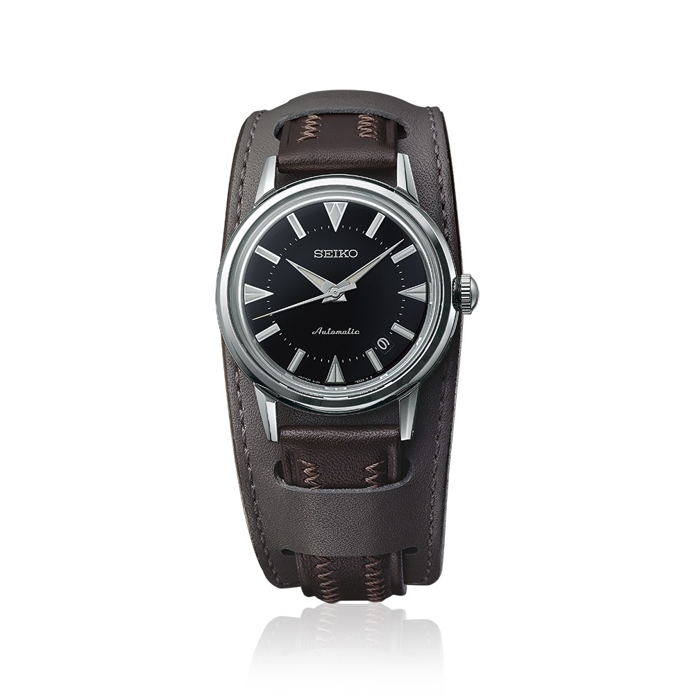 Seiko watch with black dial and brown leather strap on a white background