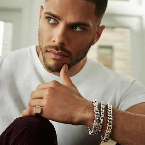 Close up of double link bracelet on model's wrist showing 9.5mm sterling silver and 18K gold links with crescent clasp