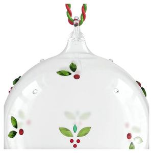 up close of mistletoe ball ornament with red and green thread on a white background