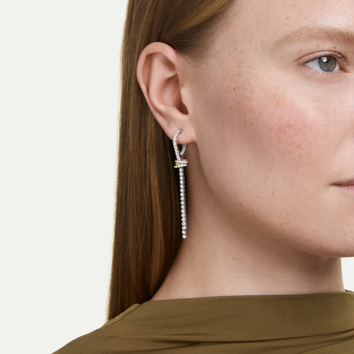 model wearing round cut stones drop earrings on a white background
