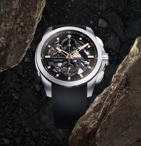 Front of NORQAIN Independence Skeleton Chrono 42mm with skeletonised dial, rose-gold hands, steel case and black rubber strap