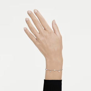 a hand and wrist wearing silver tone bracelet pearls and crystals on a white background