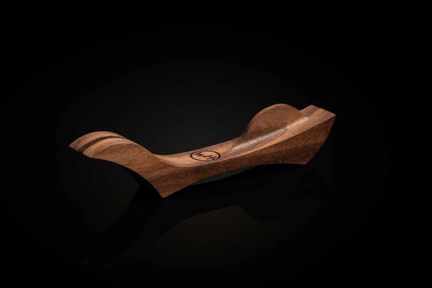 Wooden object with a logo on a black background