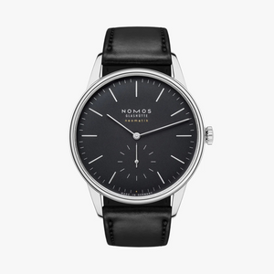 Nomos watch with black dial and strap on a white background