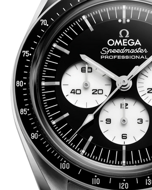 Up close view of a Omega steel watch with black dial on white background