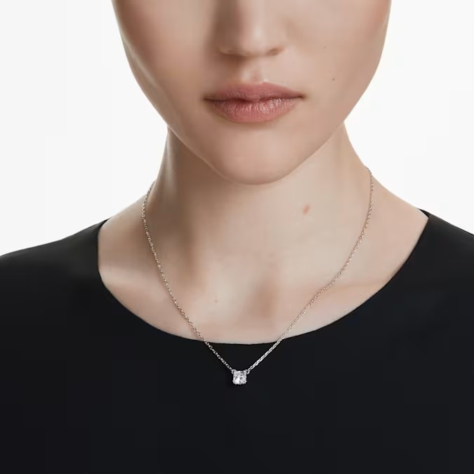 Front view of Stilla Attract Necklace, Square with square-cut Swarovski Zirconia pendant on rhodium-plated chain on model wearing a black top