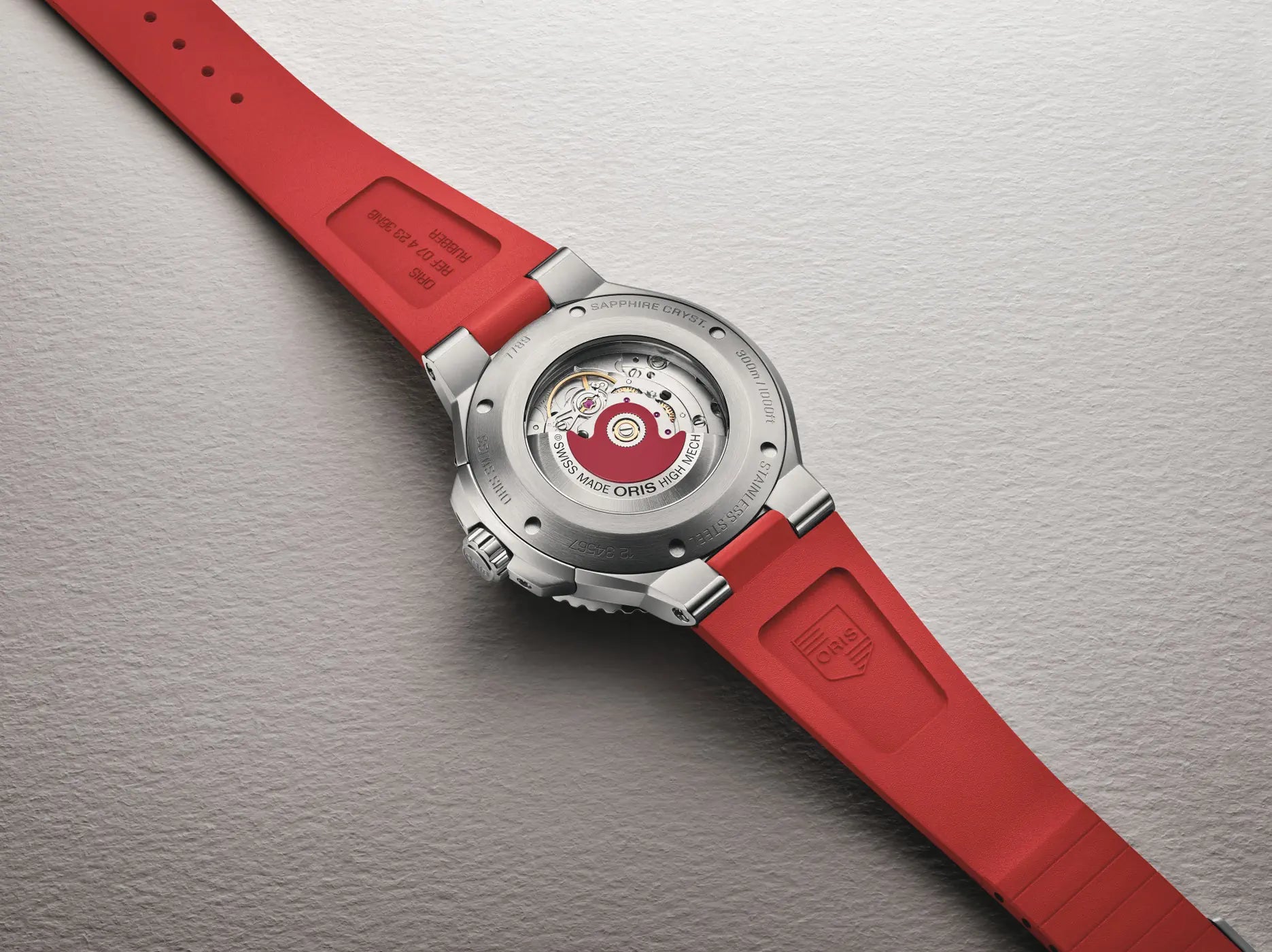 Watch with a red strap on a gray background