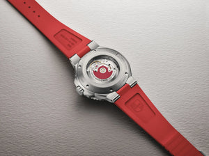 Watch with a red strap on a gray background