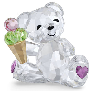 multicolored bear holding an ice cream cone on a white background
