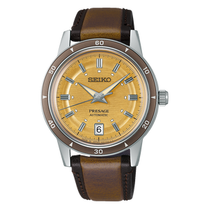 Seiko Presage watch with brown leather strap and gold dial on black background