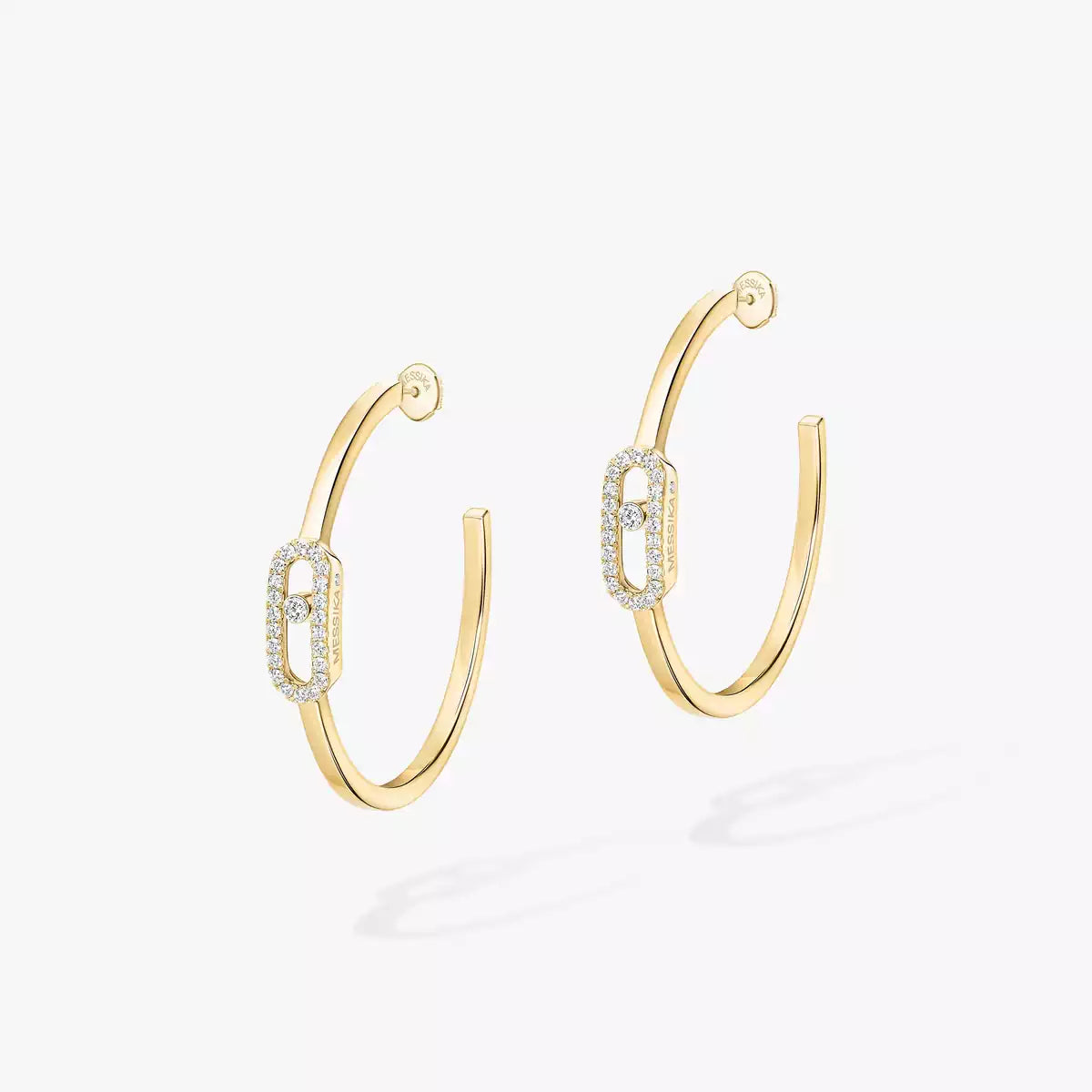 Gold hoop earrings with diamond accents on a white background
