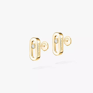 Gold earrings with 'MESSIКА' branding on a white background