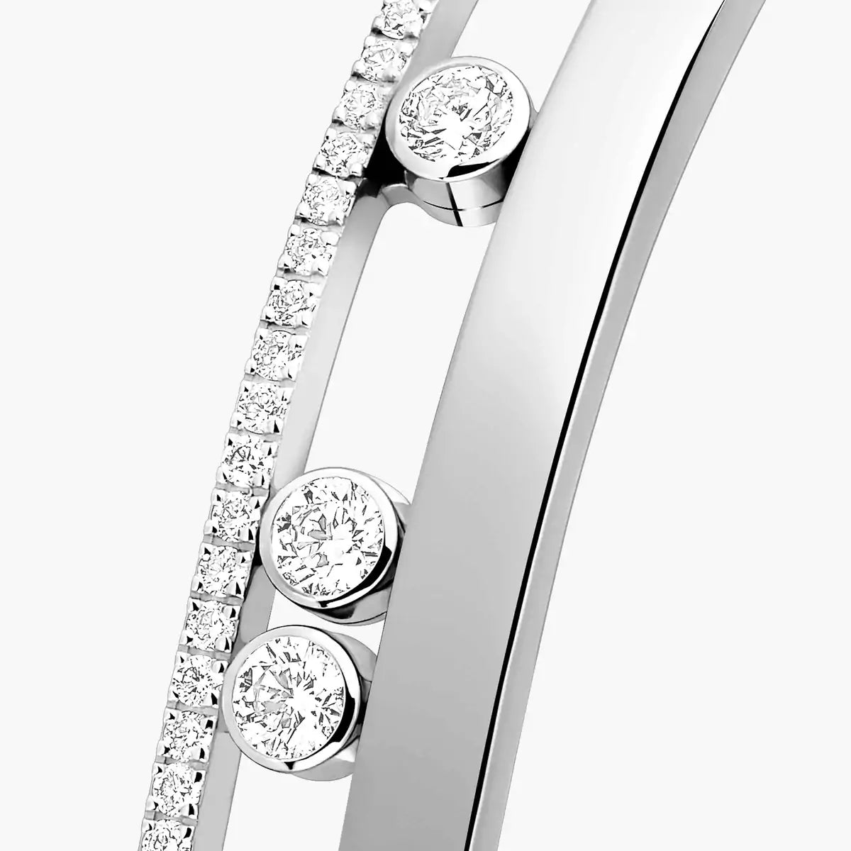 Close-up of a silver bracelet with diamond accents on a white background