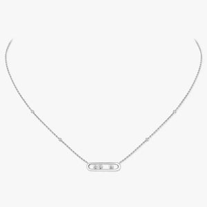 Silver necklace with a small pendant on a light gray background