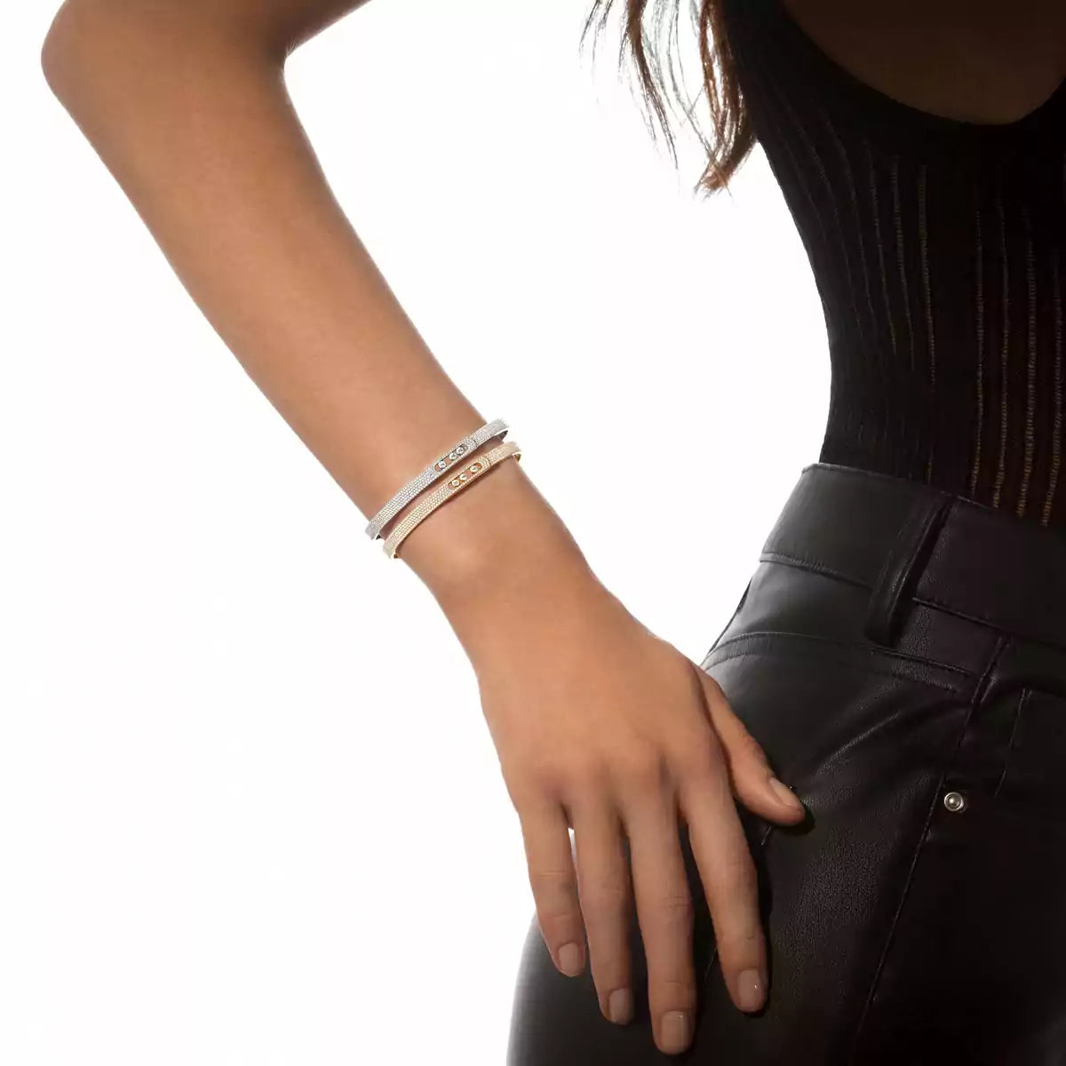 Person wearing bracelets on a white background