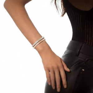 Person wearing bracelets on a white background