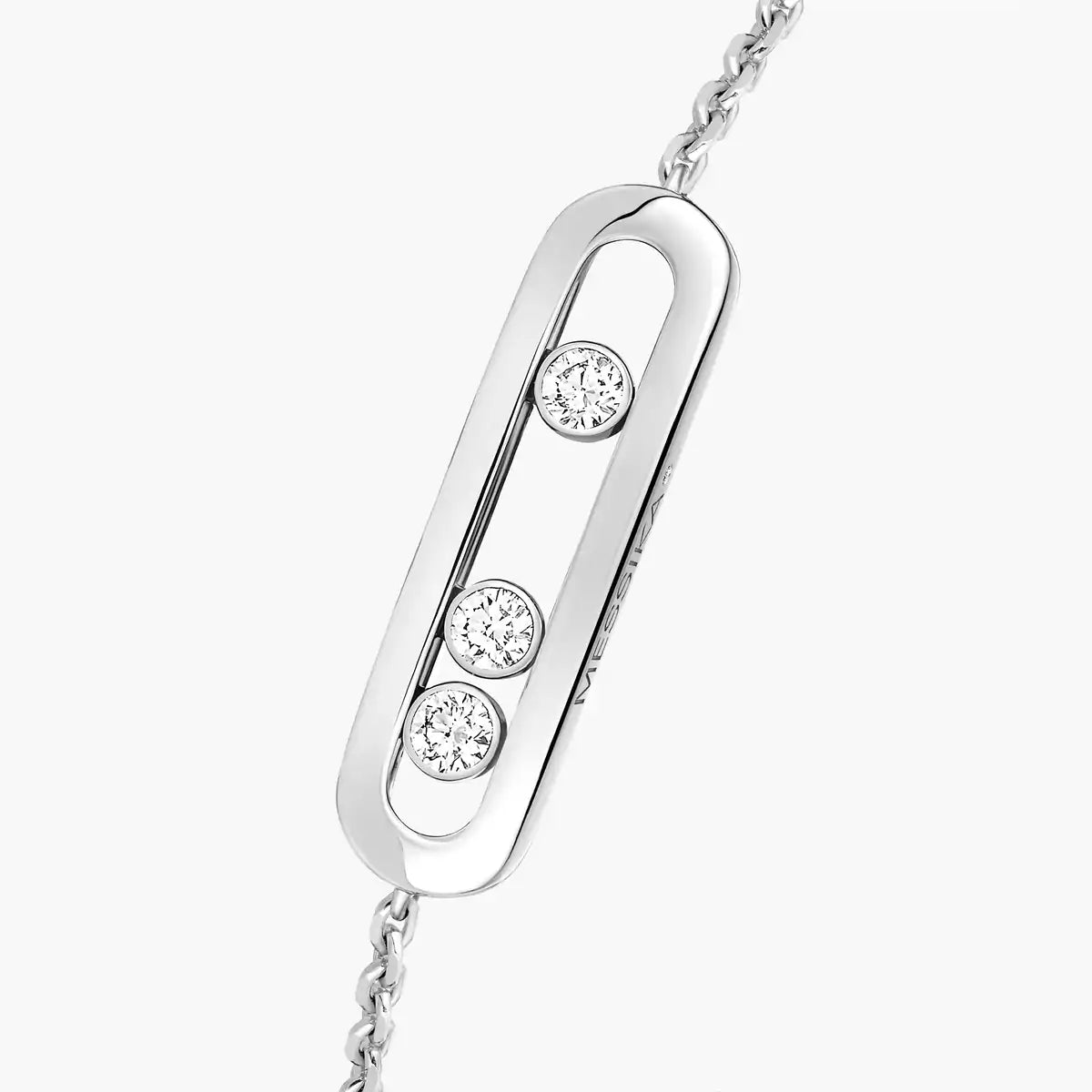 Silver necklace with three diamond pendants on a white background