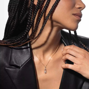 Person wearing a gold necklace with a black leather jacket